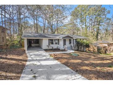 Charming one-story home featuring a well-maintained front yard and a convenient carport at 2695 Terratim Ln, Decatur, GA 30034