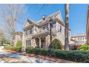 Charming two-story home featuring stone accents and a manicured front yard at 3529 S Sherwood Se Rd, Smyrna, GA 30082