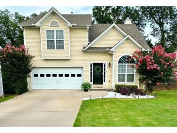 Charming two-story home with a well-maintained lawn, lovely landscaping, and an attached two-car garage at 4146 Mcever Park Dr, Acworth, GA 30101