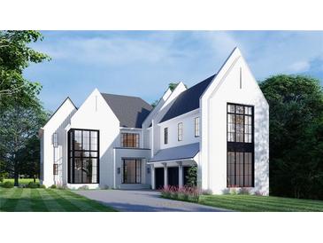 Stunning white brick home featuring high-pitched roofs, black trim windows, and an attached three-car garage at 570 Belada Blvd, Sandy Springs, GA 30342