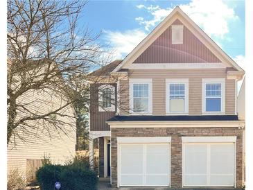 Charming two-story home with a stone facade and attached two-car garage at 922 Gardenia Curv, Canton, GA 30114