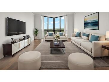 Bright living room with hardwood floors, large windows offering outside views, and modern furnishings at 2870 Pharr Court South Nw # 2901, Atlanta, GA 30305
