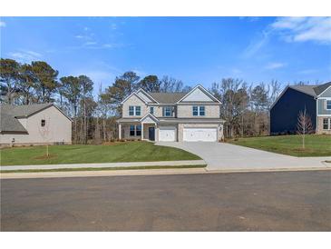Beautiful two-story brick home featuring a three-car garage and a well-manicured lawn at 124 Felicity Pike, Locust Grove, GA 30248