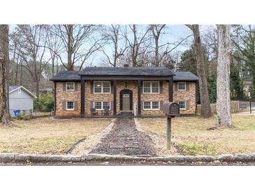 Charming brick home with a welcoming front porch and inviting curb appeal at 1343 Renee Dr, Decatur, GA 30035