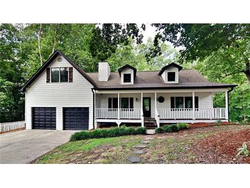 Charming two-story home features a covered porch, two-car garage, and landscaped front yard at 225 Powder Creek Dr, Dallas, GA 30157