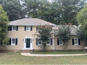 Traditional two-story home boasts black shutters, mature trees, and a classic front door at 1261 William Robert Sw Dr, Marietta, GA 30008