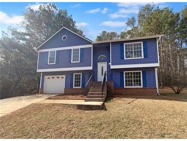 Charming two-story home with blue siding, white trim, shutters and an attached garage at 5920 Rock Rd, Union City, GA 30291