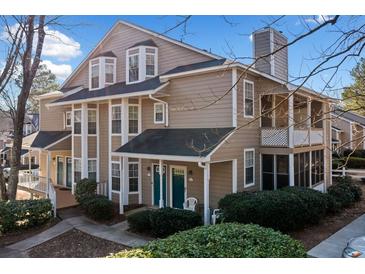 Charming condo featuring a well-maintained yard with mature landscaping, a covered porch, and a private balcony at 6420 Magnolia Way, Morrow, GA 30260