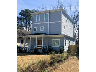 Charming two-story home with a welcoming front porch and mature landscaping at 1557 Alder Se Ct, Atlanta, GA 30317