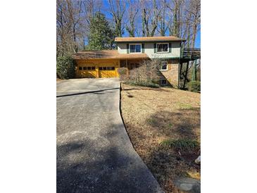 Charming split-level home with a two-car garage and a spacious front yard at 3412 Sherrod Sw Dr, Marietta, GA 30060