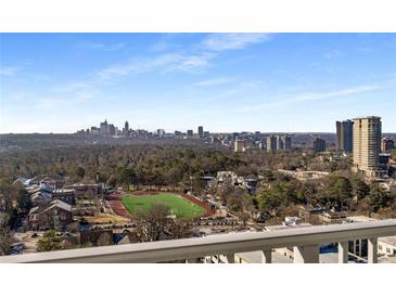 Stunning city view from the balcony, overlooking a green field, trees, and cityscape at 250 Pharr Road Northeast Ne Rd # 1813, Atlanta, GA 30305