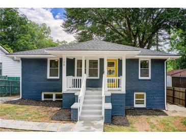 Charming bungalow with blue brick, white trim, and bright yellow front door at 198 Scott St Nw, Atlanta, GA 30314