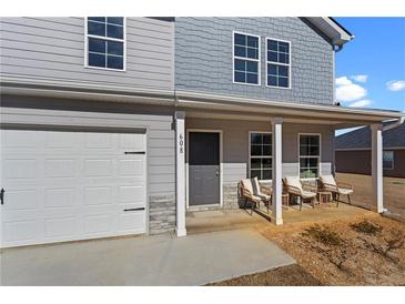 Charming two-story home with gray siding, a cozy front porch with chairs, and a one-car garage at 608 Tudor St, Euharlee, GA 30145