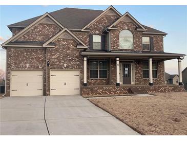 Charming two-story brick home with a covered front porch and a well-manicured lawn at 61 Denton Ct, Acworth, GA 30101