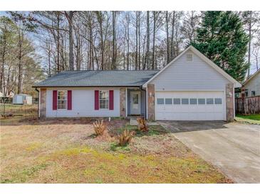 Charming single-story home featuring stone accents, red shutters, and a two-car garage at 629 Granite Ln, Loganville, GA 30052