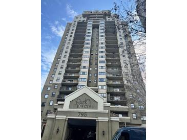 A full exterior view of the Park Towers building with many levels of balconies at 795 Hammond Dr # 1904, Atlanta, GA 30328