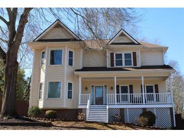 Charming two-story home with gabled roof, bay windows, and inviting front porch at 2031 Lakewood Cir, Grayson, GA 30017