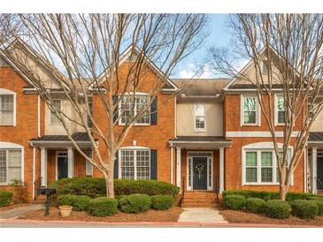 Charming brick townhouse with well-manicured landscaping and a welcoming entrance, offering great curb appeal at 4735 Longcourt Se Dr, Atlanta, GA 30339