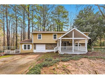 Charming two-story home with stone accents, covered porch, and a well-maintained front yard at 8640 Embrey Dr, Jonesboro, GA 30236