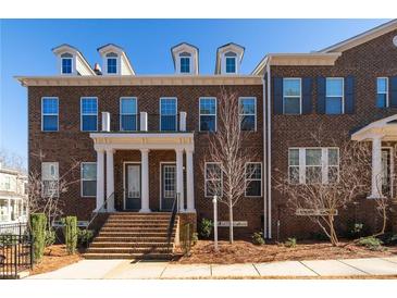 Beautiful brick townhouse exterior with a welcoming front porch, perfect for curb appeal at 715 Topsail Ln, Alpharetta, GA 30005