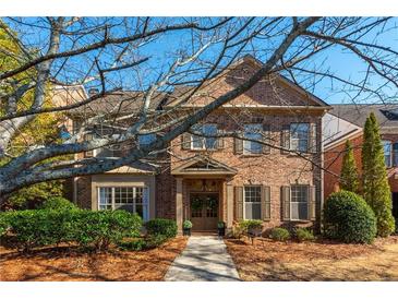 Charming brick two-story home with well-manicured landscaping and covered entryway at 1399 Legrand Cir, Lawrenceville, GA 30043