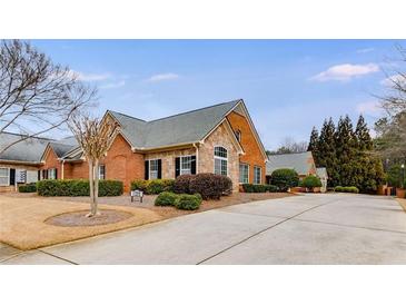 Charming brick home featuring a stone accent, mature landscaping, and a long driveway at 1404 Haven Cir, Douglasville, GA 30135