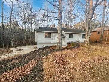 Charming home featuring a well-manicured lawn, stone walkway, and mature trees at 2658 Kellogg Creek Rd, Acworth, GA 30102