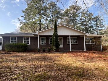 Charming brick home with manicured lawn and mature trees creating curb appeal at 3576 Pinehill Cir, Acworth, GA 30101