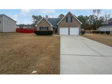Charming two-story brick home with a two-car garage and a well-maintained front yard at 213 Ermines Way, Mcdonough, GA 30253