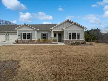 Charming single-story home featuring a well-manicured lawn, classic architecture, and inviting curb appeal at 2976 Rambler Dr, Loganville, GA 30052