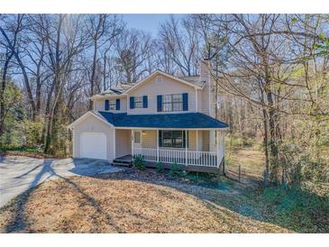 Charming two-story home with a covered front porch and a well-manicured front yard at 169 Holly Ct, Loganville, GA 30052