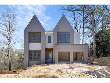 Contemporary home with gray brick, gabled roof, and a two-car garage at 2369 Drew Valley Ne Rd, Atlanta, GA 30319