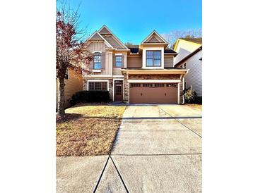 Charming two-story home featuring stone accents and a spacious two-car garage at 3476 Harvest Ridge Ln, Buford, GA 30519