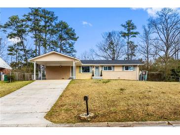 Charming ranch-style home with covered carport and well-maintained front yard at 1646 Flicker Rd, Jonesboro, GA 30238
