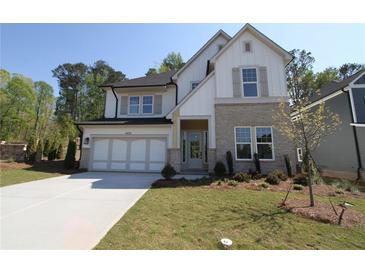 Charming two-story home with stone accents, two-car garage and inviting front yard at 4435 Beechnut Cir, Cumming, GA 30028