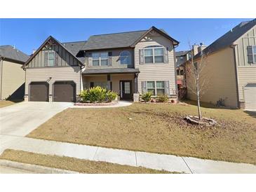 Charming two-story home featuring a two-car garage, well-maintained lawn, and welcoming front entrance at 1520 Long Acre Dr, Loganville, GA 30052