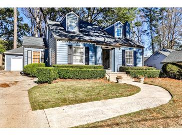 Charming blue two-story home with manicured front yard and inviting walkway at 807 Longwood Dr, Atlanta, GA 30305