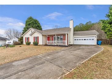 Charming single-story home with a cozy front porch, garage, and long driveway at 2685 Archer Way, Dacula, GA 30019