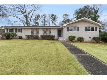 Charming single-story brick home with a well-manicured lawn and inviting walkway at 1385 Lucky Sw Ln, Mableton, GA 30126
