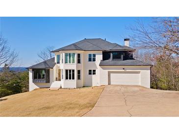 Stunning two-story home with a clean white facade, well-manicured lawn, and attached two-car garage at 2949 Summitop Ne Ct, Marietta, GA 30066