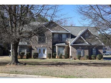 Charming brick two-story home with double front doors and manicured landscaping at 2270 Exchange Se Pl, Conyers, GA 30013