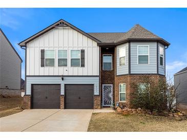 Charming two-story home with brick and siding, two-car garage and landscaped front yard at 1805 Marcelina Ln, Mcdonough, GA 30253