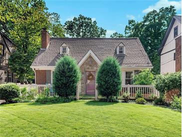 Charming cottage-style home featuring dormer windows, stone accents, and a well-manicured lawn at 427 S Columbia Dr, Decatur, GA 30030