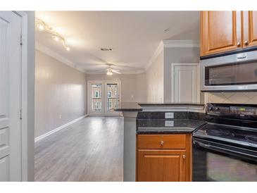 Inviting living room featuring hardwood floors and sliding glass doors to outdoor balcony at 10 Perimeter Summit Ne Blvd # 3204, Atlanta, GA 30319