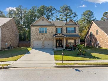 Charming two-story brick home with a well-manicured lawn, two-car garage and inviting front porch at 1118 Reddy Farm Rd, Grayson, GA 30017