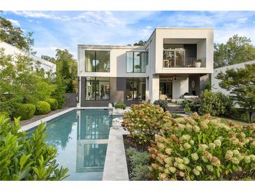 Modern home exterior with a pool, manicured garden, and outdoor living space at 1260 Brook Forest Ne Dr, Atlanta, GA 30324