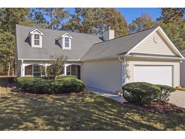 Charming home featuring a well-maintained lawn, two-car garage and dormer windows at 1150 Strath Clyde Way, Mcdonough, GA 30253