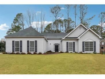 Charming single-story home featuring a well-manicured lawn and inviting entrance at 2006 Hawthorne Way, Woodstock, GA 30189
