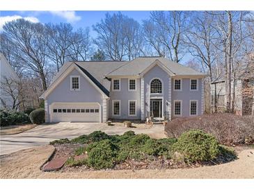 Charming two-story home features a well-maintained lawn and a classic architectural design with an attached two-car garage at 275 Sageglen Road Rd, Lawrenceville, GA 30044