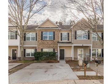 Traditional townhome featuring a well-manicured lawn and inviting facade at 1732 Broad River Rd, Atlanta, GA 30349